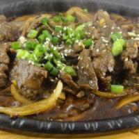Heavenly Beef · Served sizzling hot! Sliced,tender marinated beef sautéed in our special sweet sauce with on...
