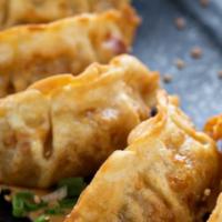 Fried Pork Gyoza (5) · Fried pork dumplings with house ginger soy dipping sauce.