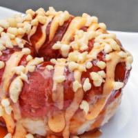 Spicy Tuna Donut · Spicy tuna donut with eel sauce and spicy mayo. Topped with tempura flakes.