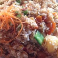Pineapple Fried Rice · Fried rice with pineapple with egg, curry powder, raisins, cashew nuts, onions, mixed vegeta...