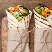 Veggie Wrap · Veggie-filled wrap featuring sliced cucumber, arugula, delectable cheese, tomatoes, and red ...