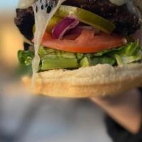 Classic Burger · Black angus beef patty, chopped romaine, tomatoes, onions and pickles, on a brioche bun. Ser...