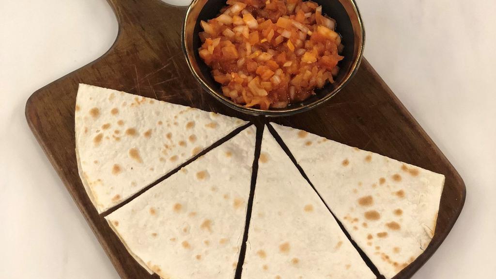 Harhoura · Harhoura (spiced chili paste, tomatoes, onions, and olive oil) on an authentic Lebanese flatbread (sajj) and baked on a convex metal griddle.