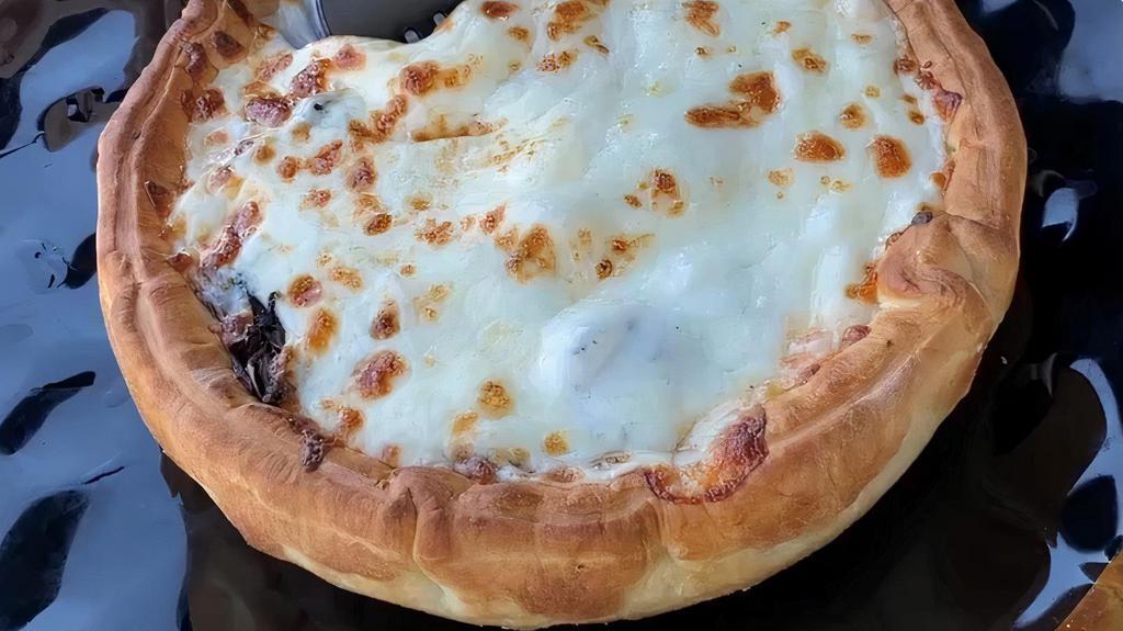 Veggie And Soujok Pizza Pot Pie · Upside down pizza with toppings within a pot pie. Toppings include: soujok (spiced beef sausage), mushrooms, green bell peppers, olives, corn, mozzarella and provolone cheese, and pizza sauce.