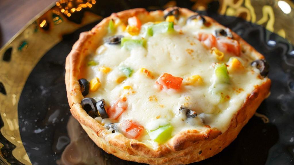 Veggiepizza Pot Pie · Upside down pizza with toppings within a pot pie. Toppings include: mushrooms, green bell peppers, olives, corn, mozzarella, provolone cheese, and pizza sauce.