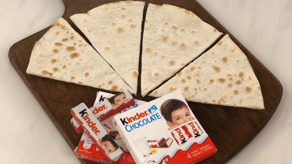 Kinder Sajj · Authentic Lebanese thin bread (sajj) filled with Kinder chocolate  and baked on a convex metal griddle.
