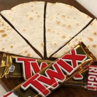 Twix Sajj · Authentic Lebanese thin bread (sajj) filled with Twix chocolate and baked on a convex metal ...