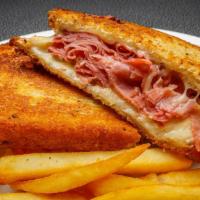 Grilled Reuben · Lean corned beef, Swiss, sauerkraut, Thousand Island dressing on rye. Served with fries.