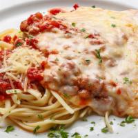 Chicken Parmigiana · Breaded and fried, topped with marinara sauce, mozzarella, Parmesan with linguine. Served wi...
