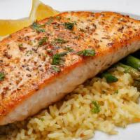Filet Of Salmon · Pan seared, topped with lemon dill beurre blanc. With rice and vegetable. Served with house ...