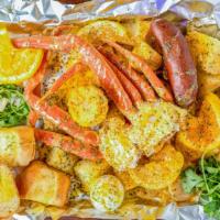Snow Crab Cluster Plate · Succulent Cajun crab cluster,  spicy sausage, seasoned cut potatoes, boiled egg, buttered co...