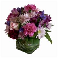 Samantha · Panache in purples! A contemporary cube is filled with carnations, roses, lavender daisies a...