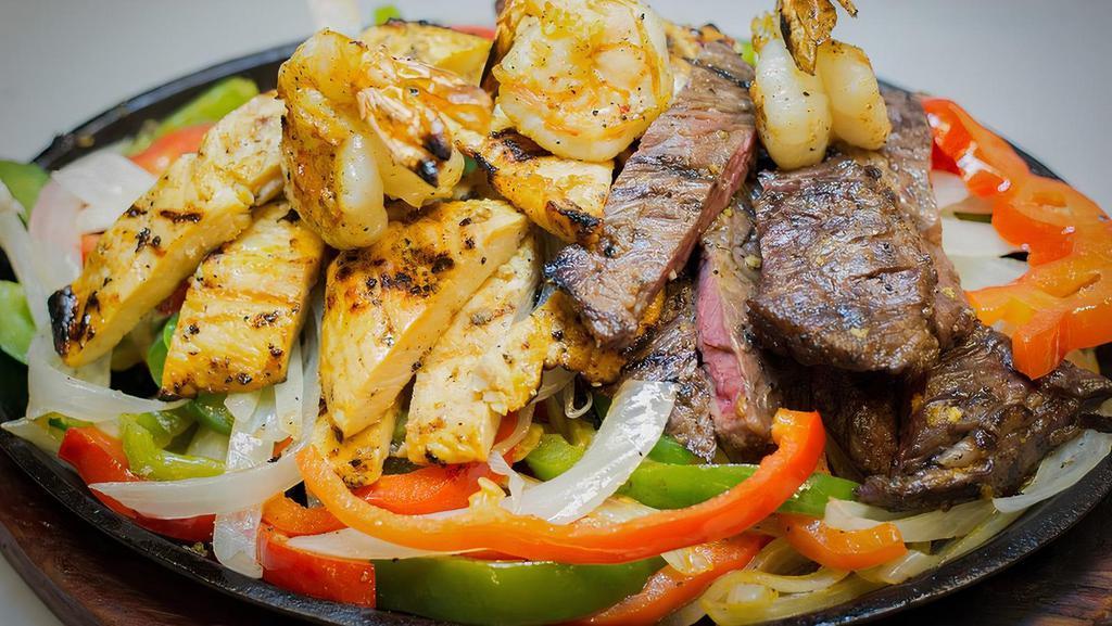 Combo Fajita · Marinated sizzling strips of steak, chicken and shrimp,
topped with sauteed onions and green peppers, served with side dish of flour tortilla, guacamole, sour cream and pico de gallo.