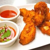 Thai Chicken Wings · Lightly battered wings deep fried and served with sweet chili sauce and spicy sauce.