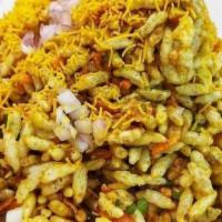 Bhel Puri · Puff rice, onions, cilantro, tomato, and chutney.