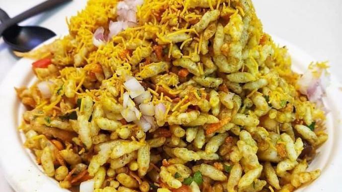Bhel Puri · Puff rice, onions, cilantro, tomato, and chutney.