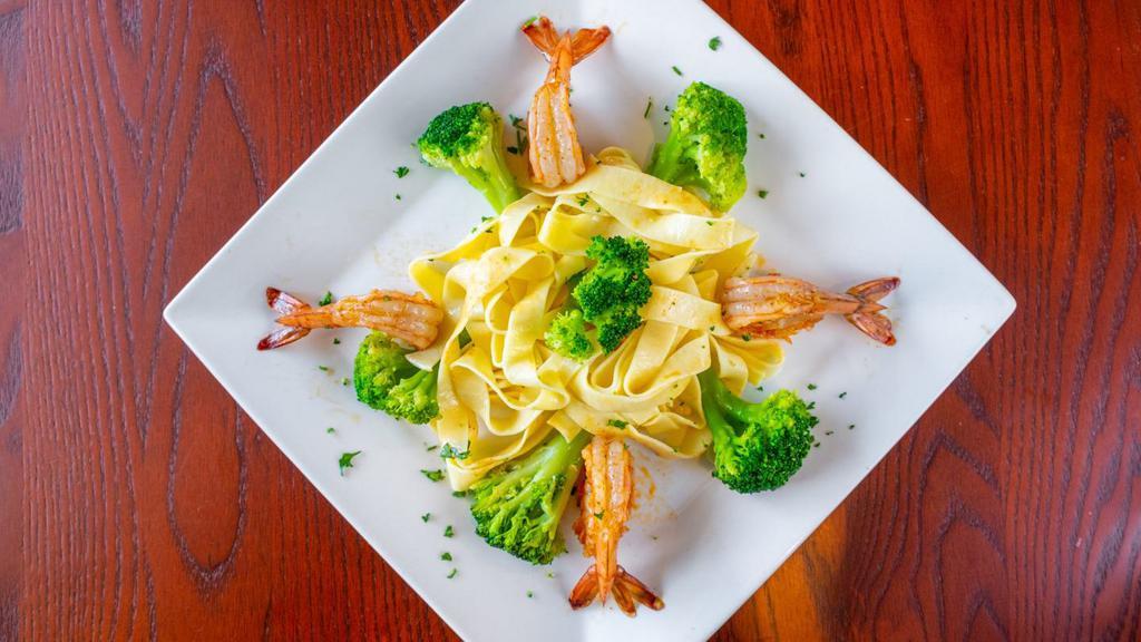 Shrimp & Broccoli Alfredo · Gulf shrimp and broccoli, sautéed in a creamy parmesan alfredo sauce served over fettuccine pasta