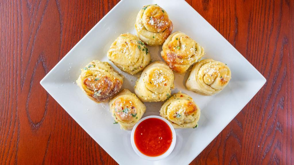 Garlic Knots · Our fresh pizza dough wrapped brushed with garlic butter, herbs and parmesan cheese.