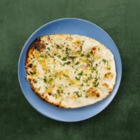 Garlic Naan · Refined wheat leavened flatbread, baked in a clay tandoor till crisp outside, and topped wit...