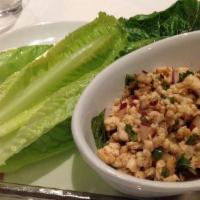 Larb · Served spicy. Minced chicken with lime juice, shallot, red chili and fresh mint leave.