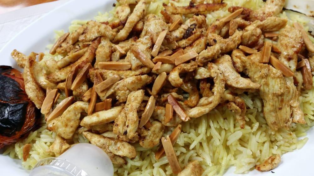 Chicken Shawarma Platter · Seasoned thinly sliced chicken breast strips with grilled onion and tomato served over basmati rice topped with almond. or over rice