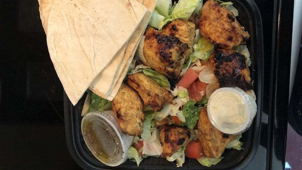 Chicken Kabob Platter · Two skewers of marinated grilled boneless chicken breast with grilled onion and tomato served over basmati rice topped with almond. or over the salad.