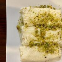 Halawet Eljibn · Three cheese dough filled with sweet cream cheese topped with pistachio and sugar syrup.