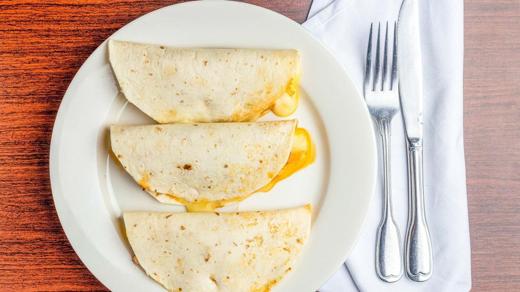 Quesadillas · Soft flour tortillas stuffed with Mexican cheese.