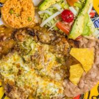 Sarape · Steak sautéed in garlic, topped with refried beans, green sauce and melted cheese served wit...