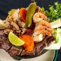 Molcajete (2 Item With Shrimp) · served with nopales cilantro queso fresco sautéed onions, avocado, rice and beans.