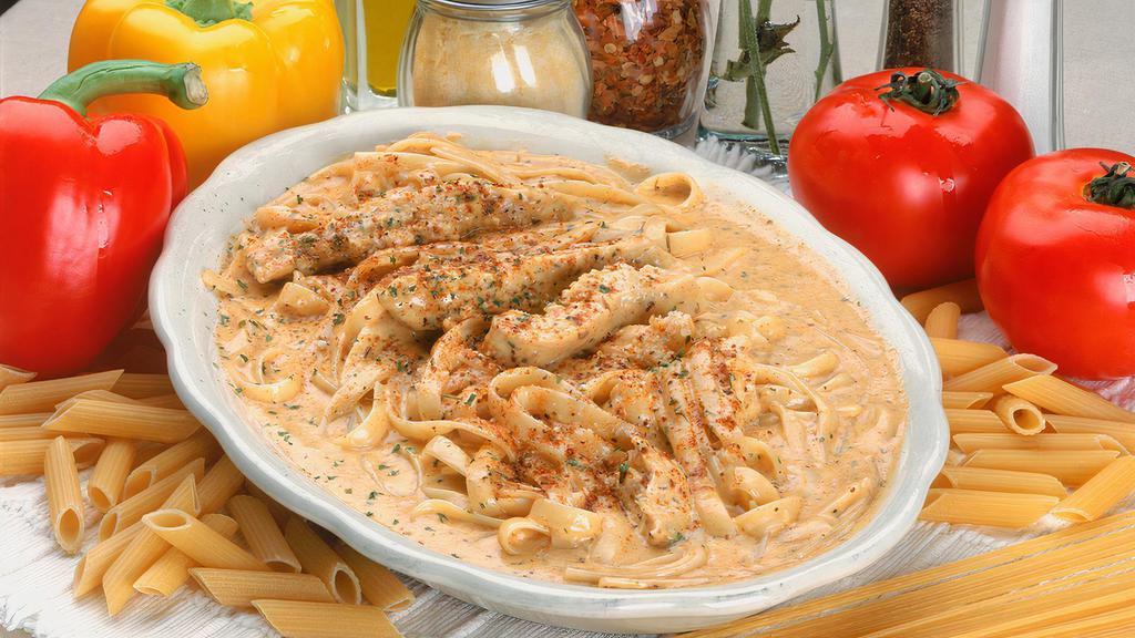Chicken New Orleans · Chicken breast tossed in our Cajun spiced cream sauce, served over a bed of fettuccine.