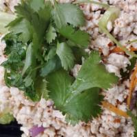 Larb Gai · Spicy. Steamed minced chicken, rice powder, red onions dried peppers in a lime vinaigrette.