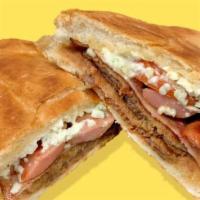 Torta Cubana · Cuban Sandwich. Telera bread, stuffed with breaded beef, pork, hot-dog, ham and melted chees...