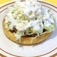 Sope  · Deep fried corn masa, topped with refried beans, lettuce, fresco cheese and meat of your cho...