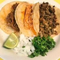 Corn Taco · Served with cilantro, onions and limes on the side. 1 oz. red or green sauce.