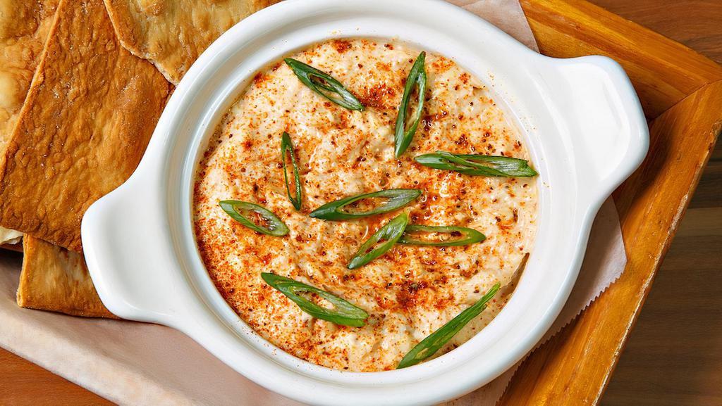 Baked Crab Dip · lump crab meat, scallions, white cheddar & parmesan served w flatbread crackers