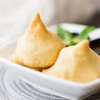 Samosa (2 Pcs) · Fried crispy pastry turnover filled with mashed potato and peas. Served with tangy chutney.