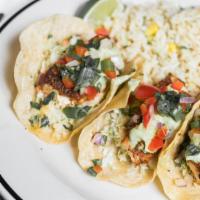 Fish Tacos · Cajun-seared haddock, apple slaw, avocado crema and cilantro on fresh corn tortillas, with v...