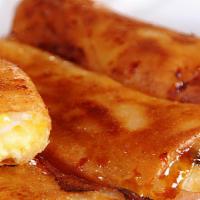 Turon  · Sweet Banana and Jackfruit rolled into a thin egg crepe and fried to a golden crisp (1pc).