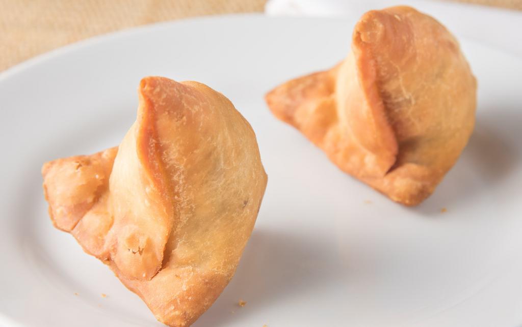 Vegetable Samosa (2) · Crispy turnovers filled with mild spiced potatoes and green peas.