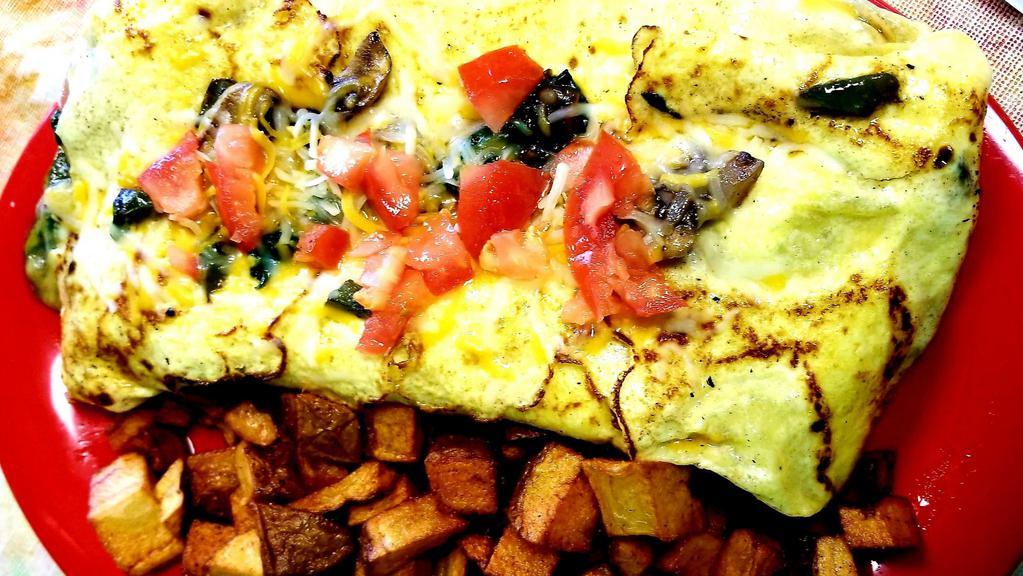 Garden Omelet · Mushrooms, spinach, bell peppers, onions, tomatoes, cheese with side.