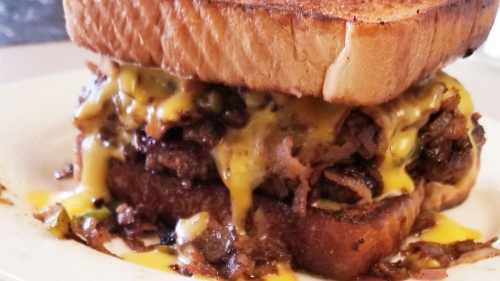 Texas Cheese Steak Burger · Philly Steak, patty, sauteed onions and bell peppers, Swiss cheese, and queso on Texas Toast.