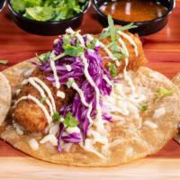 Fish Corn Taco · Breaded and fried cod topped with red cabbage and tangy aioli, served with lime wedges on a ...