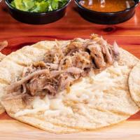 Flour Taco De Carnitas · A soft flour tortilla topped with cheese and our traditional carnitas. Served with cilantro,...