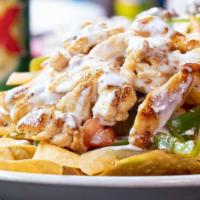 Fajita Nachos ⭐️ · Nachos piled high with your choice of chicken or steak grilled with tomatoes, onions, and gr...