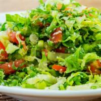 Medium Tabouli Salad · Mixture of romaine lettuce, parsley, scallions, tomatoes and cracked wheat, served with lemo...