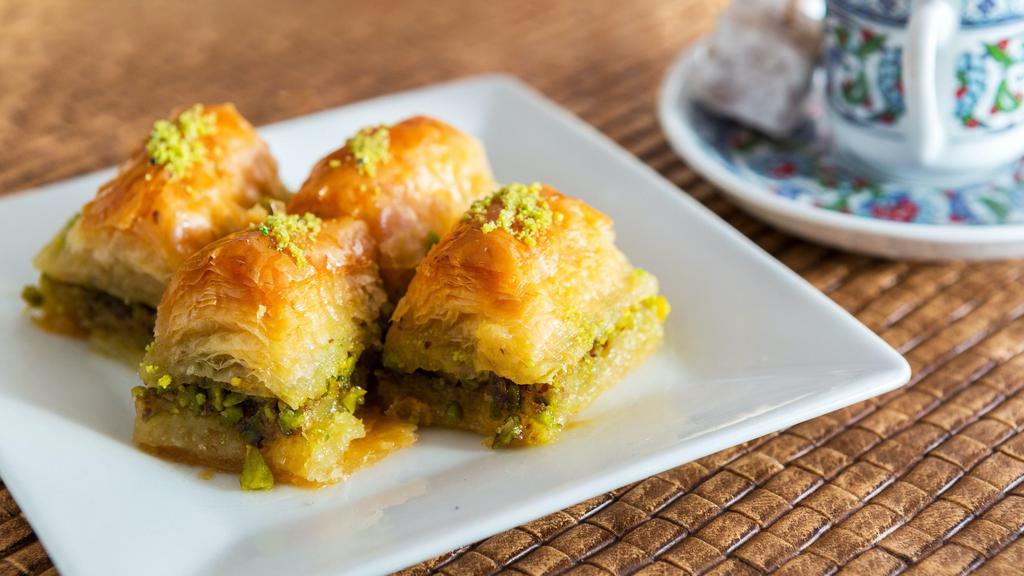 Baklava · Layers of paper-thin dough filled with crushed pistachios. Contains dairy and gluten.