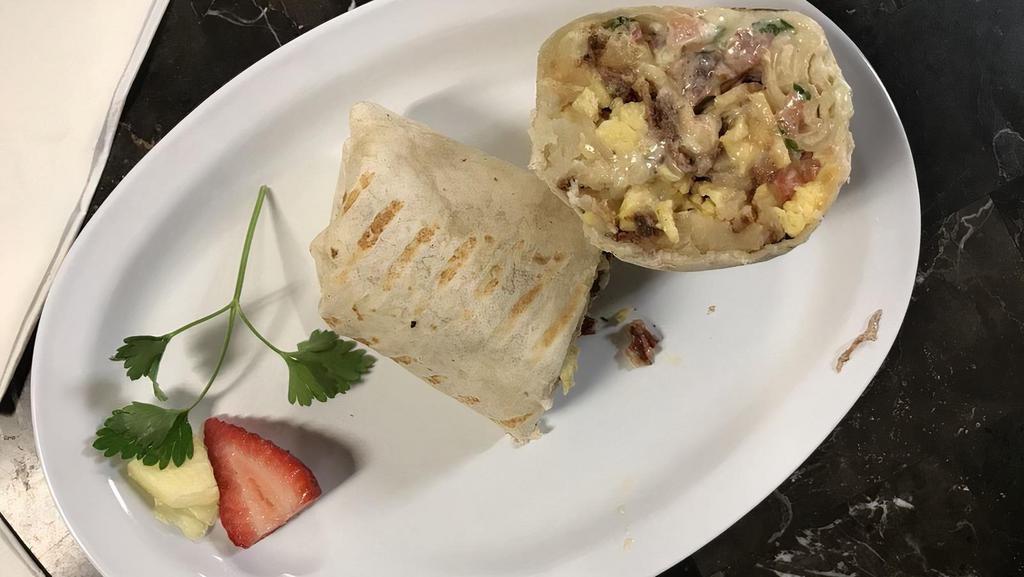 Breakfast Burrito · Your choice of bacon, umu pork, or veggies with eggs, hash browns, sliced cheese, pico de gallo, & house sour cream. Add fresh avocado for an additional cost.