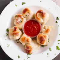Garlic Knot · Bread, topped with garlic & olive oil or butter, herb seasoning, baked to perfection. Melts ...