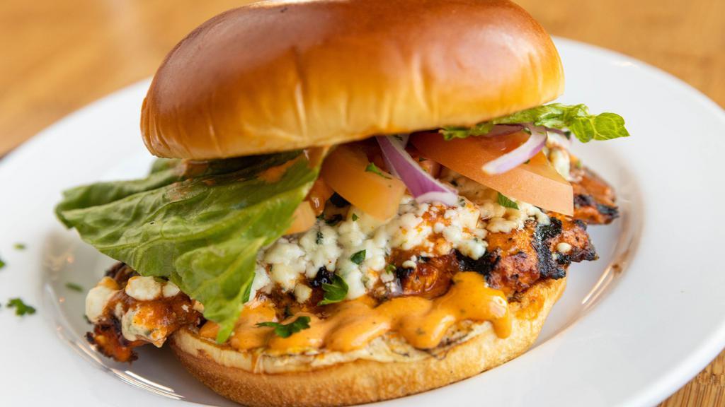 Buffalo Chicken Sandwich · Grilled chicken breast, garlic-herb hot sauce, gorgonzola, Romaine, red onion, tomato, house dressing, and brioche roll. Served with Artemis fries.